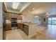 Modern kitchen featuring stainless steel appliances and tiled backsplash open to a spacious living area at 3 Riverwalk Dr # 404, New Smyrna Beach, FL 32169