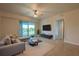 Living room featuring comfortable seating, a modern TV setup, and access to a balcony at 3 Riverwalk Dr # 404, New Smyrna Beach, FL 32169