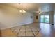 Bright living room featuring a ceiling fan, sliding glass doors, and views of the outdoor greenery at 3 Riverwalk Dr # 404, New Smyrna Beach, FL 32169