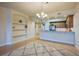 View of the bright living space, complete with built-in shelving and an adjacent modern kitchen at 3 Riverwalk Dr # 404, New Smyrna Beach, FL 32169