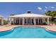 Community swimming pool featuring poolside seating, a covered pavilion, and lush landscaping at 3 Riverwalk Dr # 404, New Smyrna Beach, FL 32169