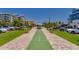 Community shuffleboard court surrounded by sidewalks, grassy areas, and parking at 3 Riverwalk Dr # 404, New Smyrna Beach, FL 32169