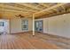 Large partially covered patio with wood flooring and backyard access at 310 Main St, Enterprise, FL 32725