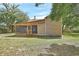 Exterior view of backyard with screen porch and home at 310 Main St, Enterprise, FL 32725