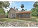 Exterior view of house from backyard with screened in porch at 310 Main St, Enterprise, FL 32725