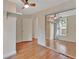 Bedroom featuring hardwood floors, sliding closet, and natural lighting at 310 Main St, Enterprise, FL 32725