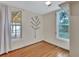 Inviting bedroom featuring hardwood floors, tree art, natural light, and serene ambiance at 310 Main St, Enterprise, FL 32725
