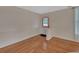 Cozy bedroom with hardwood floors, neutral paint, and a sunny window at 310 Main St, Enterprise, FL 32725