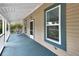 Charming covered porch featuring wooden flooring and a view of the property at 310 Main St, Enterprise, FL 32725