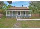 Charming two-story home with a welcoming front porch and well-maintained lawn at 310 Main St, Enterprise, FL 32725