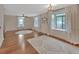 Spacious living room featuring hardwood floors, large windows, and modern lighting at 310 Main St, Enterprise, FL 32725