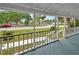 Inviting front porch features a painted deck, railing, and a view of the neighborhood at 310 Main St, Enterprise, FL 32725