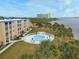 An aerial view showcasing the community pool, lush green lawns, and bay views in this condo complex at 3131 S Ridgewood Ave # 4120, Daytona Beach, FL 32119