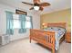 Comfortable bedroom with natural light, a ceiling fan, and a cozy bed at 3131 S Ridgewood Ave # 4120, Daytona Beach, FL 32119