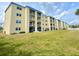 Spacious condominium with white balconies and a blue roof, surrounded by lush green grass at 3131 S Ridgewood Ave # 4120, Daytona Beach, FL 32119
