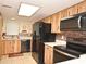 Bright kitchen featuring a refrigerator, dishwasher, microwave, and a view of the sink at 3131 S Ridgewood Ave # 4120, Daytona Beach, FL 32119