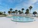 Beautiful kidney-shaped pool, surrounded by palms and lounge chairs, overlooking calming bay waters at 3131 S Ridgewood Ave # 4120, Daytona Beach, FL 32119