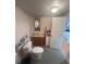 Functional bathroom featuring a vanity, toilet, and view to the kitchen at 328 W Connecticut Ave, Lake Helen, FL 32744