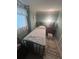 Compact bedroom features a simple bed and a quaint, cozy atmosphere at 328 W Connecticut Ave, Lake Helen, FL 32744