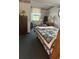 Cozy bedroom with a comfortable bed, complemented by natural light from the window at 328 W Connecticut Ave, Lake Helen, FL 32744