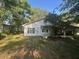 This single-story home features a sunroom and classic architecture at 328 W Connecticut Ave, Lake Helen, FL 32744