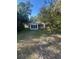 Charming single-story home featuring a quaint front yard and mature trees at 328 W Connecticut Ave, Lake Helen, FL 32744