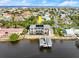 Aerial view of waterfront property with a boat dock and screened-in pool at 3310 John Anderson Dr, Ormond Beach, FL 32176