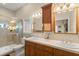 Well-lit bathroom with double sinks, tile countertops, and a walk-in shower at 3310 John Anderson Dr, Ormond Beach, FL 32176