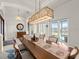 Elegant dining area features modern light fixture, access to outdoor living, and tile floors at 3310 John Anderson Dr, Ormond Beach, FL 32176
