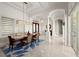Bright dining room boasting modern light fixture, columns, and view to the entry at 3310 John Anderson Dr, Ormond Beach, FL 32176