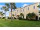 Stunning two-story home with lush landscaping and mature palm trees at 3310 John Anderson Dr, Ormond Beach, FL 32176