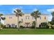 Stately two story home with manicured lawn and palm trees at 3310 John Anderson Dr, Ormond Beach, FL 32176