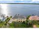 Waterfront home with a lush lawn, stately palm trees and views of the open bay at 3310 John Anderson Dr, Ormond Beach, FL 32176