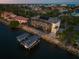 Aerial view shows boat dock, waterfront access, and full pool screen at 3310 John Anderson Dr, Ormond Beach, FL 32176