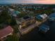 Aerial view showcases home with private boat dock, screened pool, and waterfront location at 3310 John Anderson Dr, Ormond Beach, FL 32176