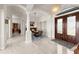 Elegant foyer with marble floors and columns, leading to the dining room at 3310 John Anderson Dr, Ormond Beach, FL 32176