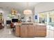 Open-concept kitchen with granite countertops, modern appliances, and a stunning chandelier at 3310 John Anderson Dr, Ormond Beach, FL 32176