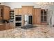 Kitchen island with stainless appliances, custom cabinetry, and bright lighting at 3310 John Anderson Dr, Ormond Beach, FL 32176