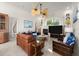 Bright living room featuring fireplace, neutral paint, and large windows at 3310 John Anderson Dr, Ormond Beach, FL 32176