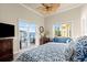 Bright main bedroom overlooking water with desk and comfortable furniture at 3310 John Anderson Dr, Ormond Beach, FL 32176