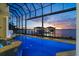 Screened in pool featuring views of the inter coastal waterway at sunset at 3310 John Anderson Dr, Ormond Beach, FL 32176