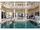 Enclosed pool area with a spa, lots of seating, ceiling fans, and covered patio space at 3310 John Anderson Dr, Ormond Beach, FL 32176