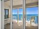 Spacious balcony with comfortable seating offering stunning views of the ocean and bright blue skies at 3425 S Atlantic Ave # 1206, Daytona Beach Shores, FL 32118