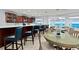 This bar area has a large countertop, bar seating, plus dining tables for relaxing with ocean views at 3425 S Atlantic Ave # 1206, Daytona Beach Shores, FL 32118