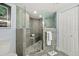 Modern bathroom featuring a glass walk-in shower, seating, and neutral tile at 3425 S Atlantic Ave # 1206, Daytona Beach Shores, FL 32118