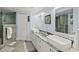 Bathroom featuring a double vanity with granite counters and a glass enclosed shower at 3425 S Atlantic Ave # 1206, Daytona Beach Shores, FL 32118