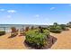 Brick patio overlooking the beach with lounge chairs, landscaping, and easy beach access at 3425 S Atlantic Ave # 1206, Daytona Beach Shores, FL 32118
