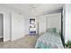 Cozy bedroom with a Murphy bed, quilt, tile floors and an ocean view at 3425 S Atlantic Ave # 1206, Daytona Beach Shores, FL 32118