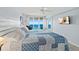 Bright bedroom featuring an ocean view, ceiling fan, and a comfy quilt at 3425 S Atlantic Ave # 1206, Daytona Beach Shores, FL 32118