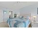 Inviting bedroom featuring a comfy quilt and a view of the ensuite bathroom at 3425 S Atlantic Ave # 1206, Daytona Beach Shores, FL 32118